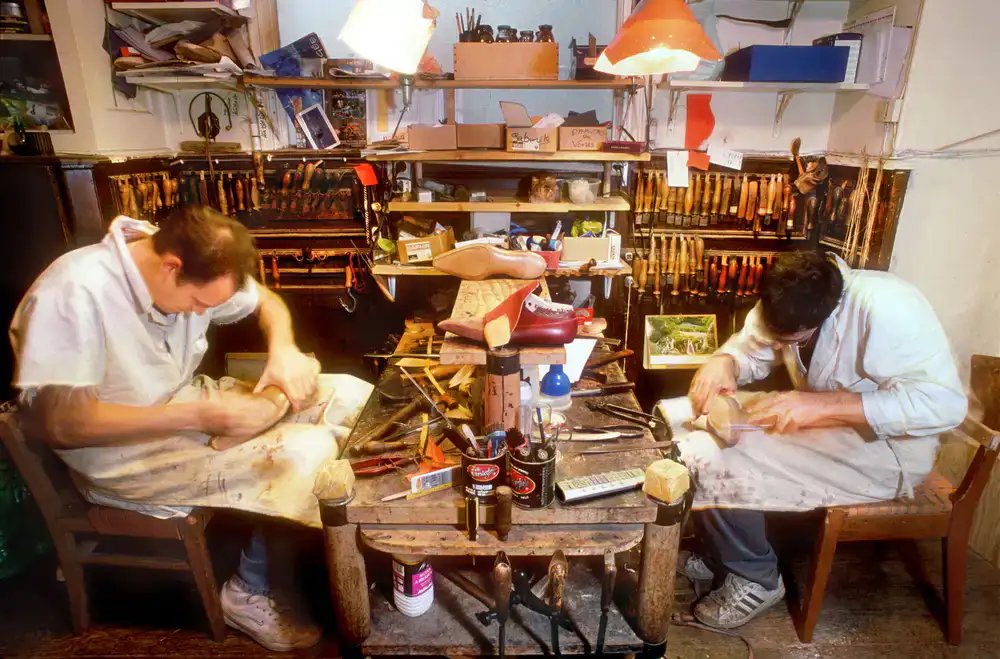 Cobbler tools laid out on a leather workbench