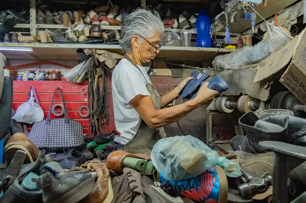 Cobbler repairing a leather shoe in the workshop