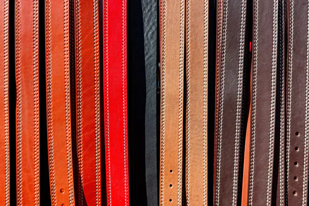 Handmade leather belts and accessories carefully arranged on display