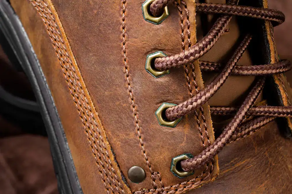 Detailed leather stitching repair on a boot