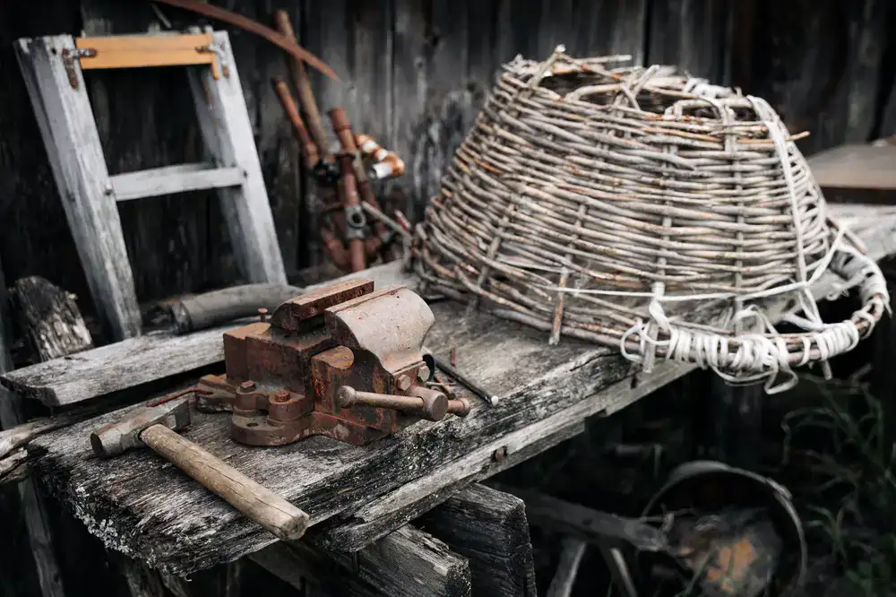 Traditional shoe repair tools resting on a worn wooden workbench